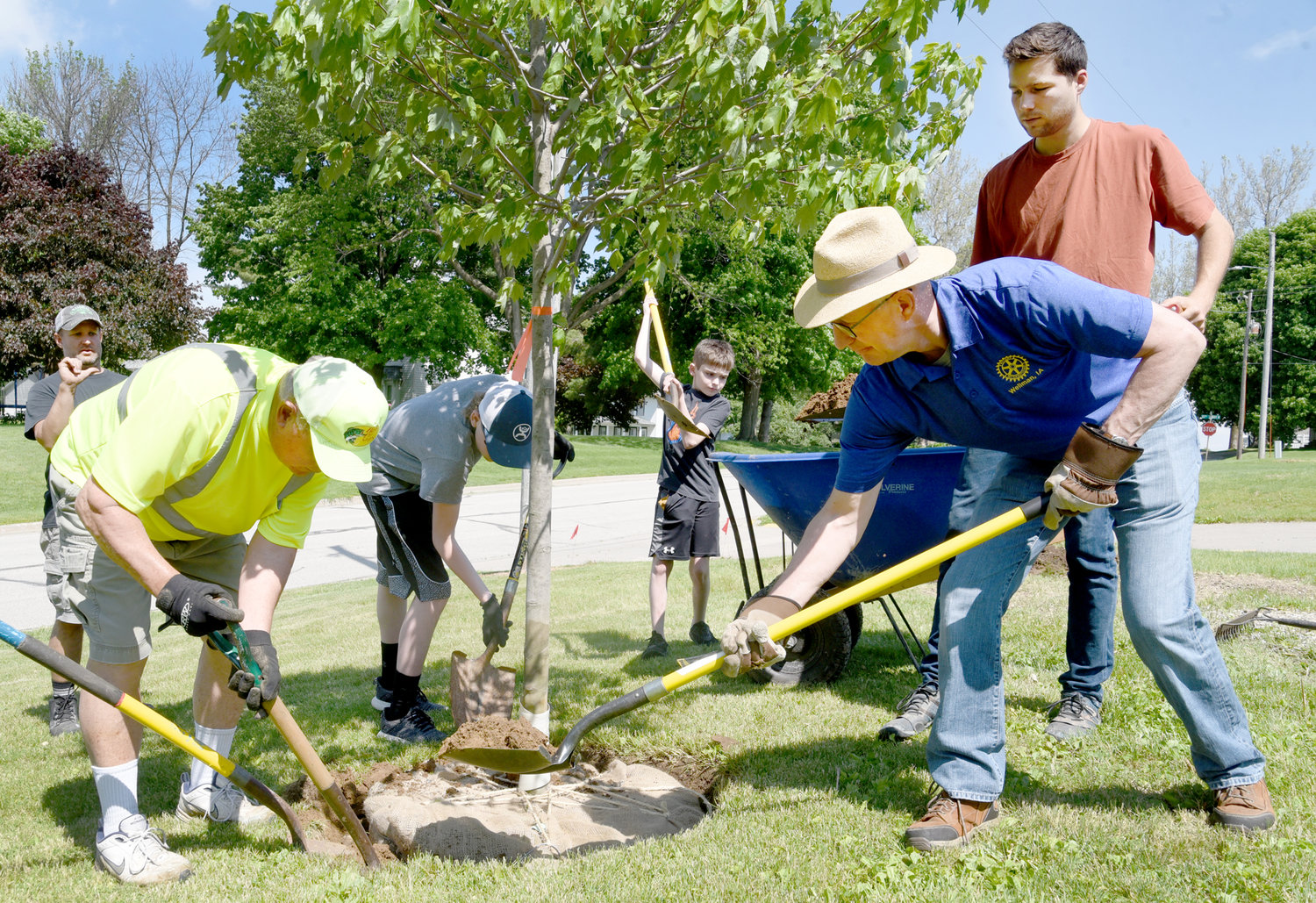 From left, Leroy Powell, Kelyn Yoder and Allen Leichty fill in a hole with dirt. In the background, Jason Yoder and Jonah Van Roekel shovel dirt from a wheelbarrow.